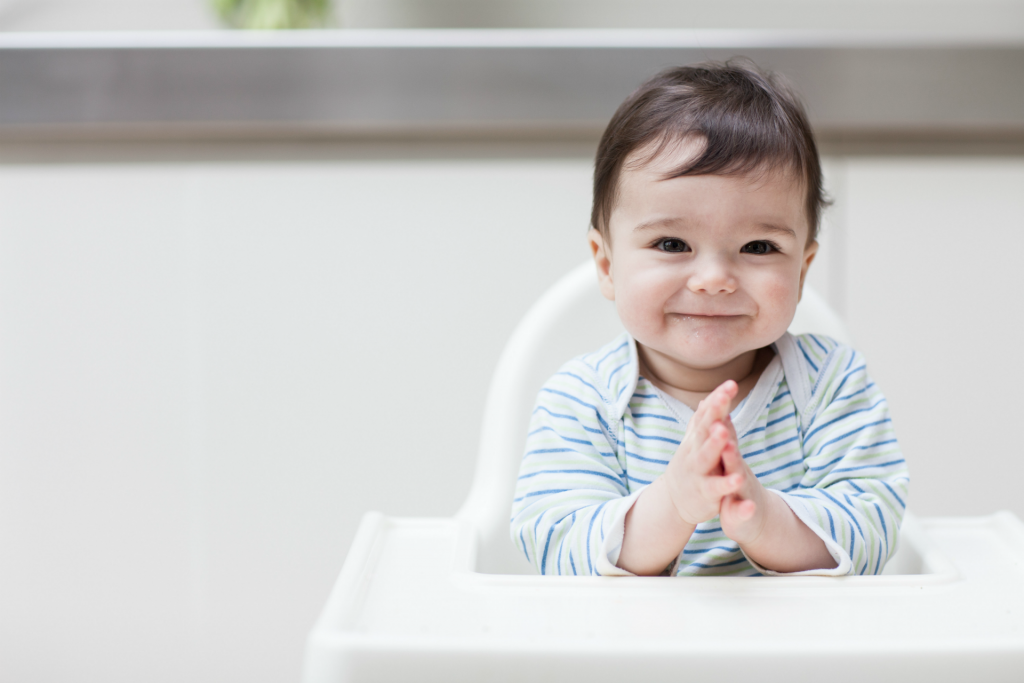 Happy baby in high chair