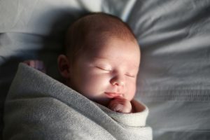 co-sleeping baby in a moses basket