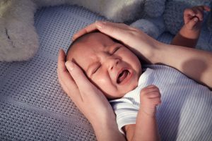 Baby boy in crib crying - controlled crying
