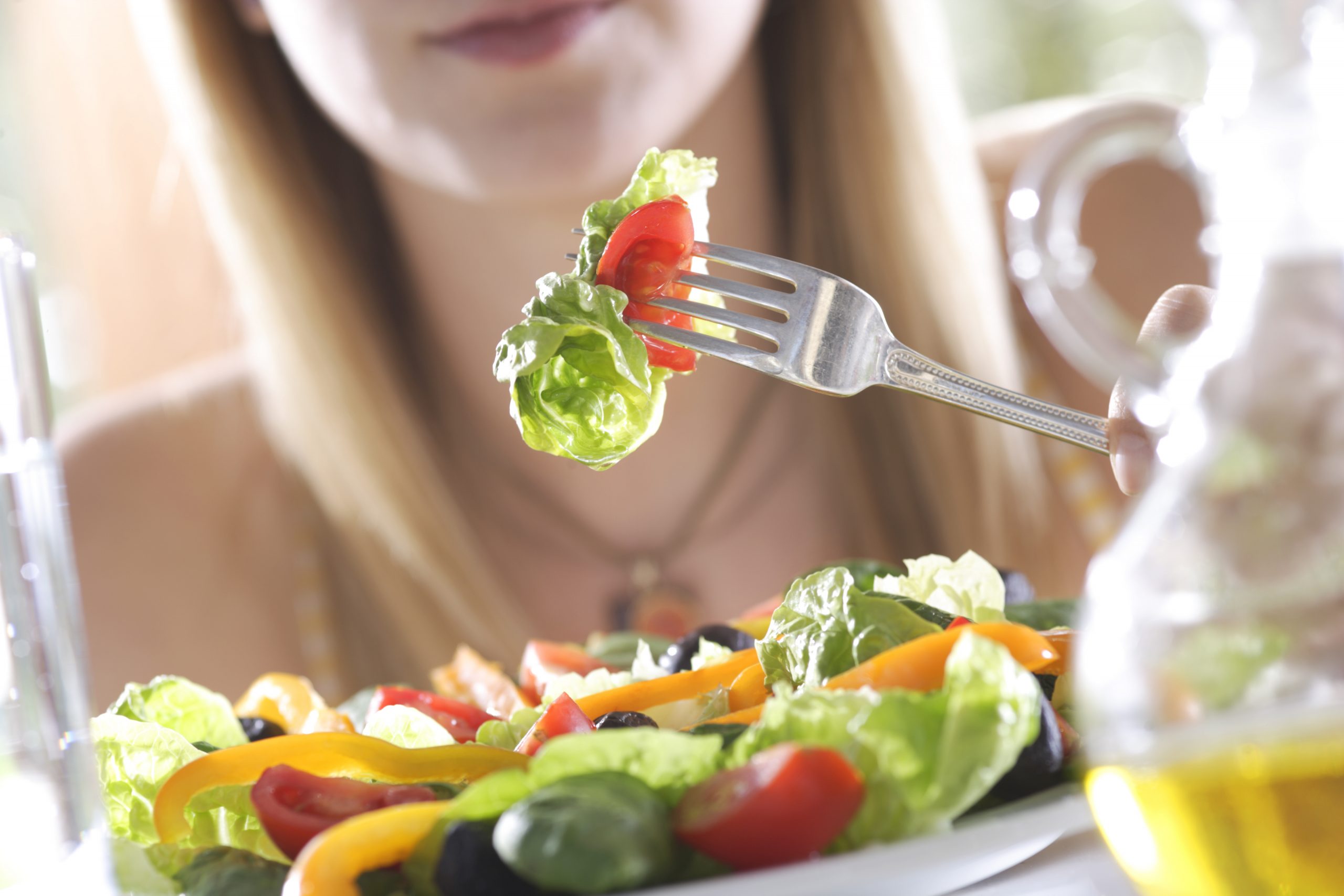 Avoid relationship weight gain: woman eating salad