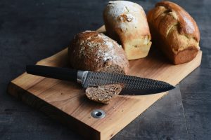 Three different loaves on a bread board