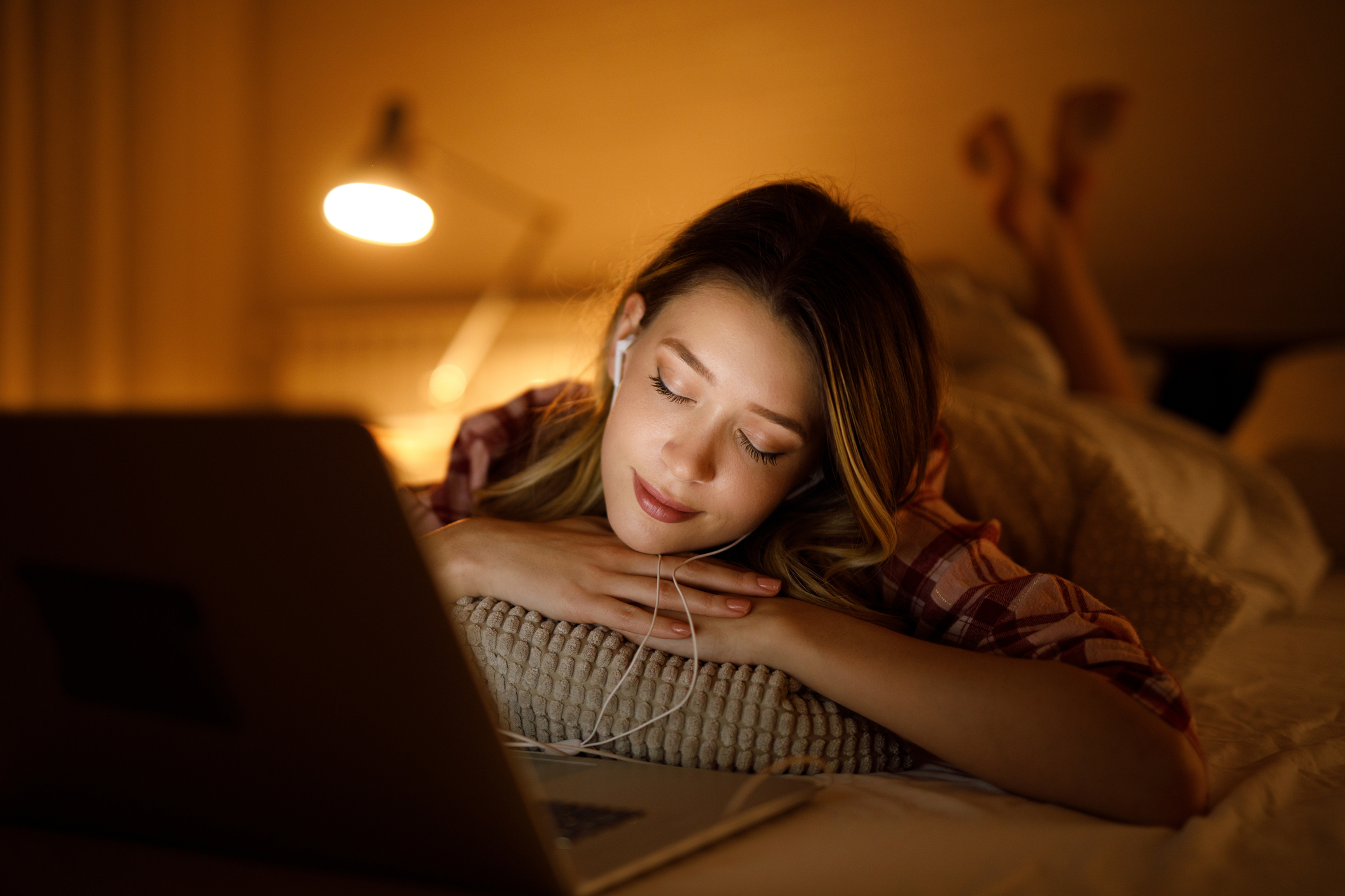 woman listening to music in bed