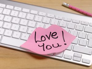 Post-it note stuck to keyboard with the words "I Love you" written on it