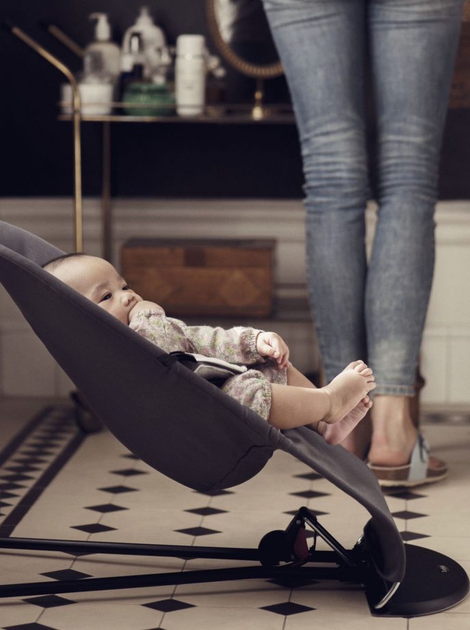 A baby in a baby bouncer