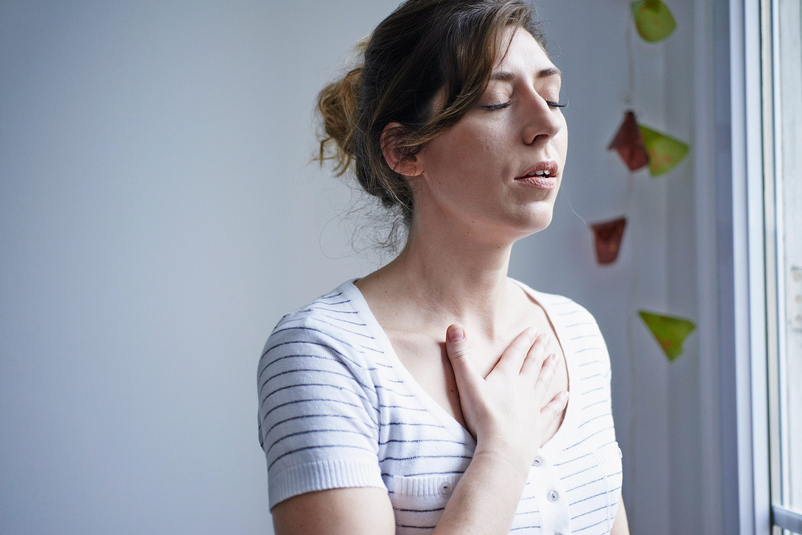 Woman with asthma holds her chest