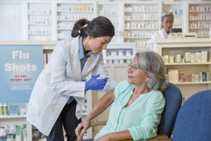 woman having the flu vaccine administered