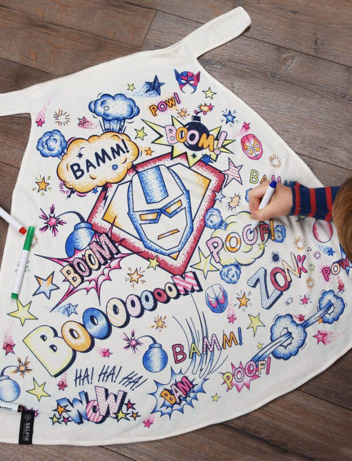 A child colouring in a Superhero Colour In Cape