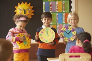 kids in a class room learning how to tell the time