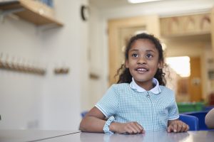 girl in school uniform in classroom