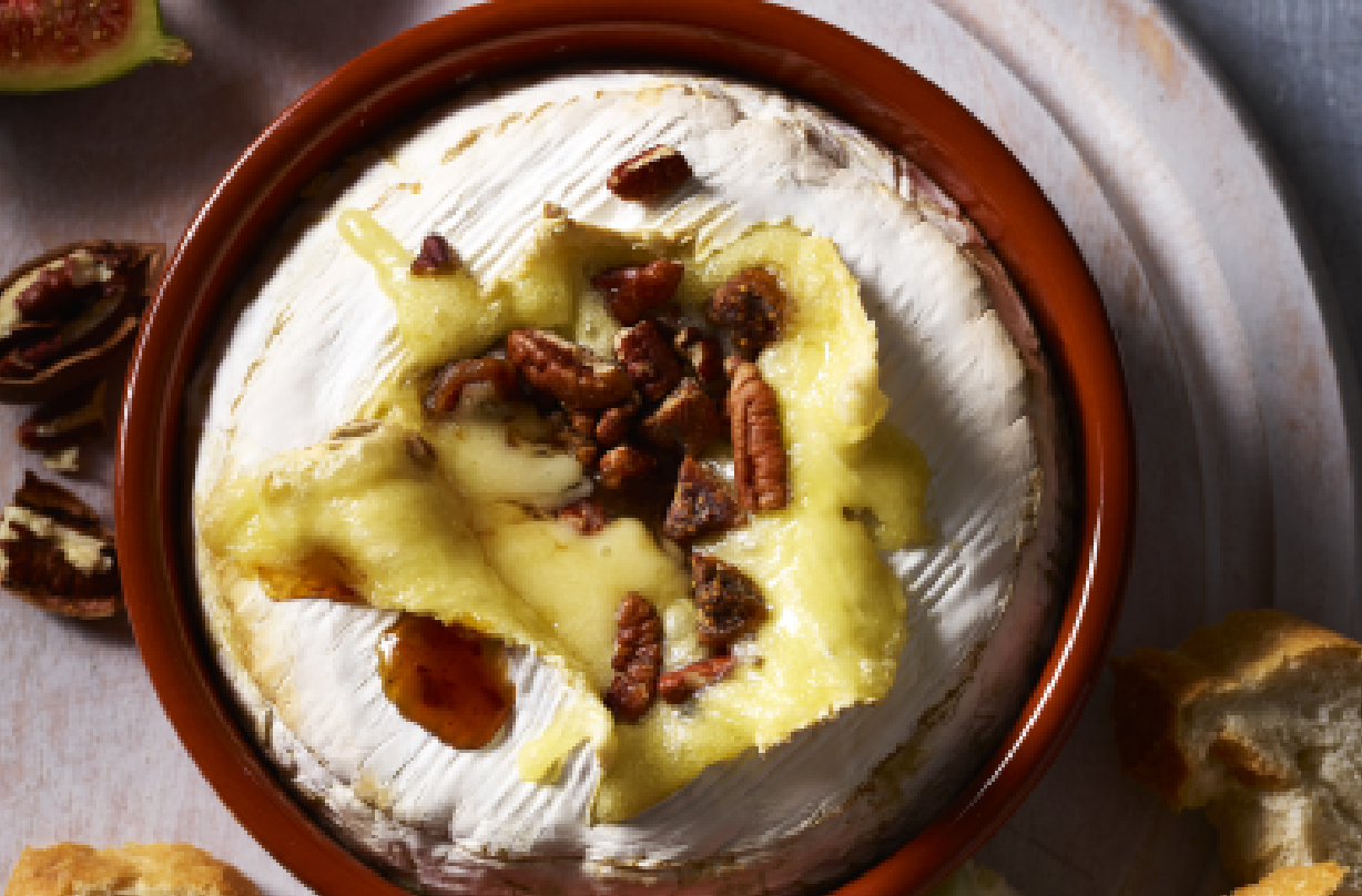 Large baked Camenbert in a pot topped with raisins