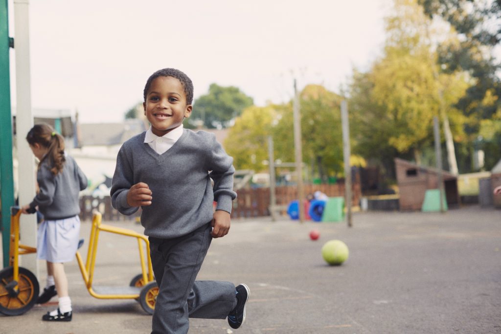 boy running in the playground - back to school safety