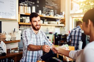 man handing over a card machine - eat out to help out september