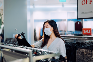 woman wearing mask clothing shopping - black friday vs. cyber monday