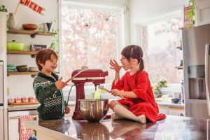 Two children baking cookies together