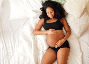 Pregnant Woman Lying On Bed - Pelvic Pain in Pregnancy