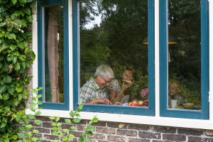 grandmother and family eating inside in tier one of lockdown restrictions