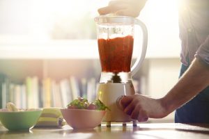 woman whizzing a sauce in a blender