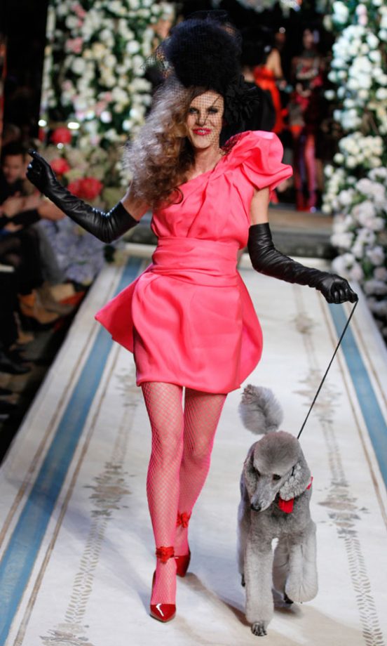 Anna Dello Russo Editor Of Vogue Japan Walks The Catwalk In A Hot Pink Dress With A Giant Poodle At The Lanvin For H&M Haute Couture New York Fashion Show 2010