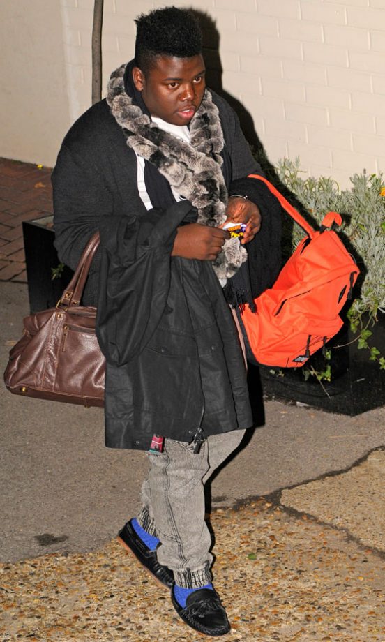 X Factor Finalist Paije Richardson Adds A Pop Of Colour To His Grey Look With Bright Blue Socks And An Orange Backpack