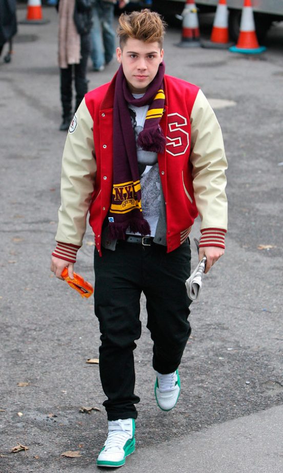 Aiden Grimshaw Goes For A Collegiate Look In A Red and White Varsity Jacket At The X Factor Studios
