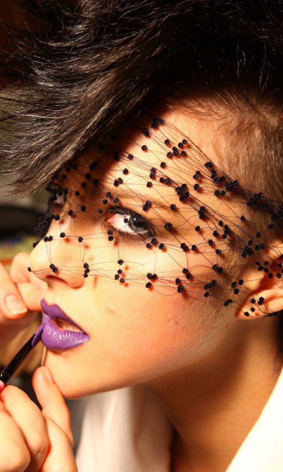 A Model Shines Through Her Veil With Bright Purple Rock Star Lips At The Lanvin For H&M Haute Couture New York Fashion Show 2010