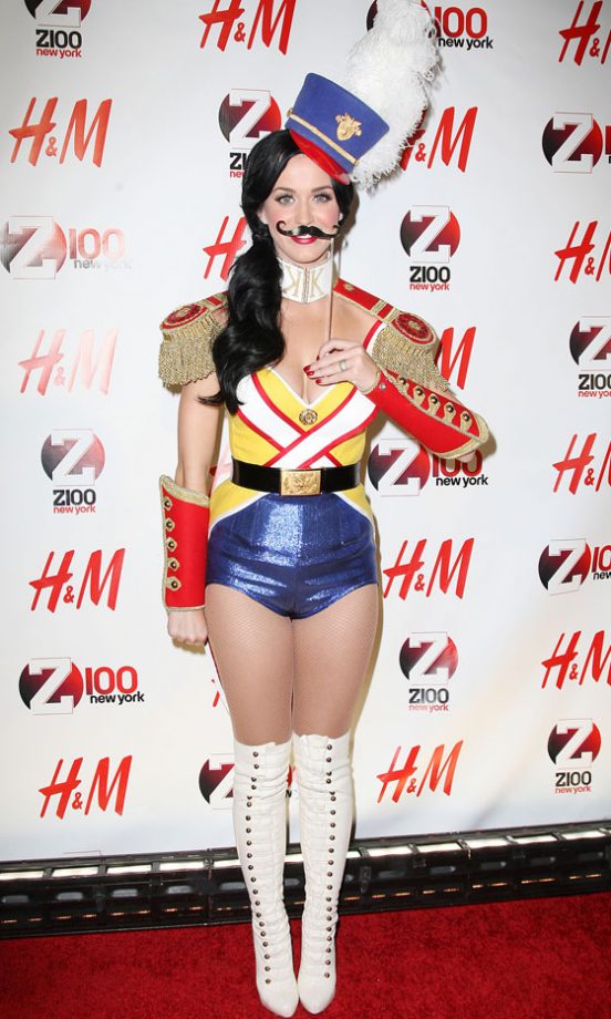 Katy Perry Makes Like A Cheeky Toy Soldier And Stands To Attention, 'Tache And All, December 2010