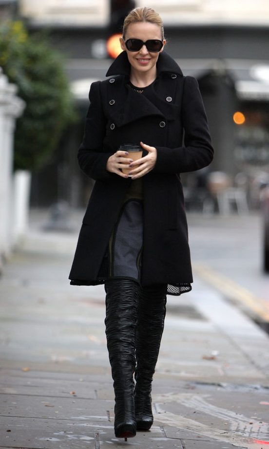 Kylie Minogue Does Off-Duty Cool To Perfection In A Classic Black Coat And Knee-High Boots, 2011