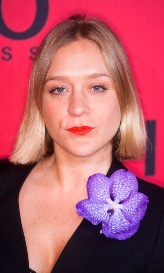 Chloë Sevigny Opts For Paintbox Brights With Orange Lipstick And A Purple Corsage At Berlin Fashion Week, January 2011