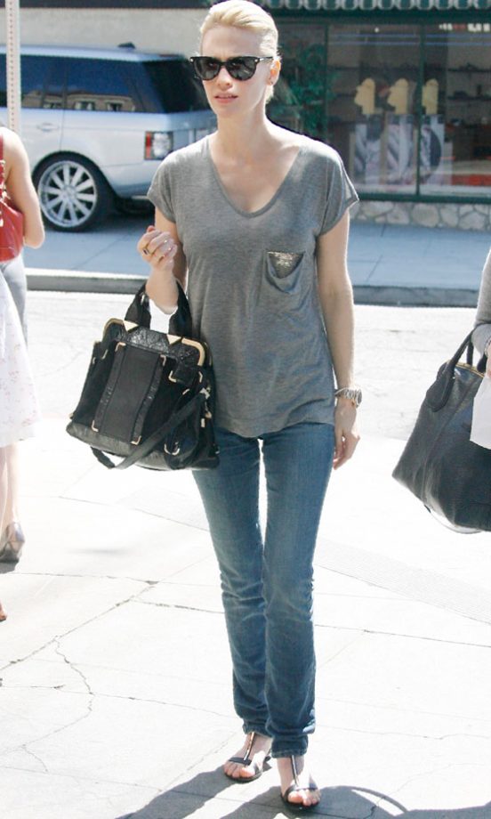January Jones Adds Glamour To A Casual Outfit With A Designer Bag And Sunglasses, 2011