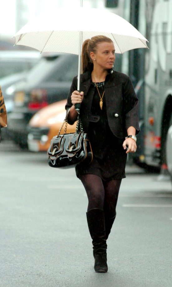 Coleen Rooney Braves The Miserable Weather In Style With A Patent Fendi Handbag And Black Suede Boots, March 2006