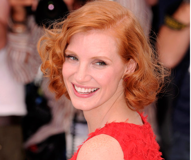Jessica Chastain matches her locks with her fashion