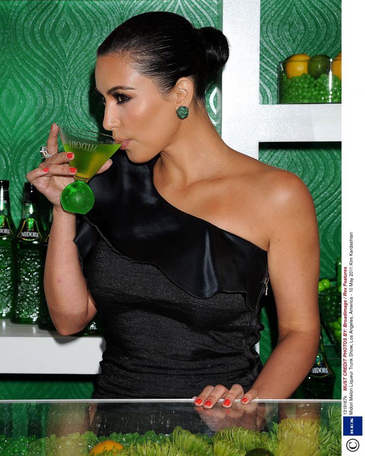 Smooth Hair Back Into A Ponytail With Plenty Of Hairspray To Get Kim Kardashian's Super Sleek Hairstyle, 2011