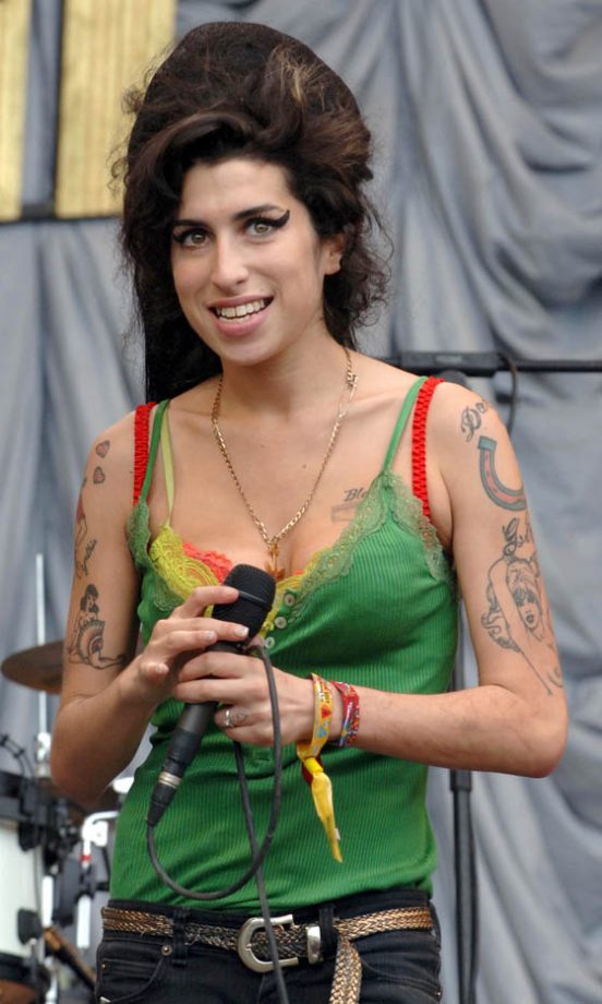Amy Winehouse At Glastonbury In 2007 With All Her Glad Rags And Wrist Bands On