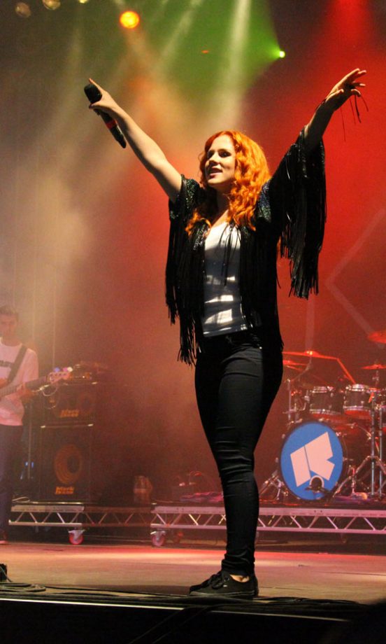Katy B On Stage In Tim Ryan Fringed Cardigan, Topshop Jeans And Vans Trainers At V Festival 2011
