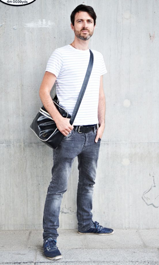 Hugo Barritt Wearing Adidas Originals Trainers And A Fred Perry Bag From Urban Outfitters