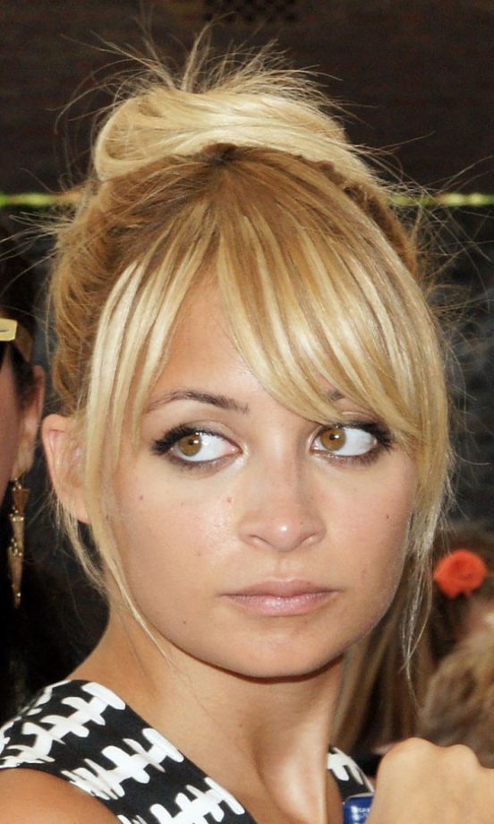Nicole Richie Works The Top Knot Hairstyle Trend With A Parted Fringe, 2011