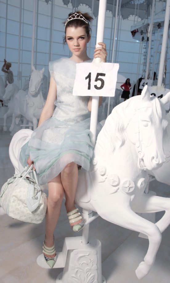 A Model Poses On The Carousel At The Louis Vuitton SS12 Show At Paris Fashion Week, 2011