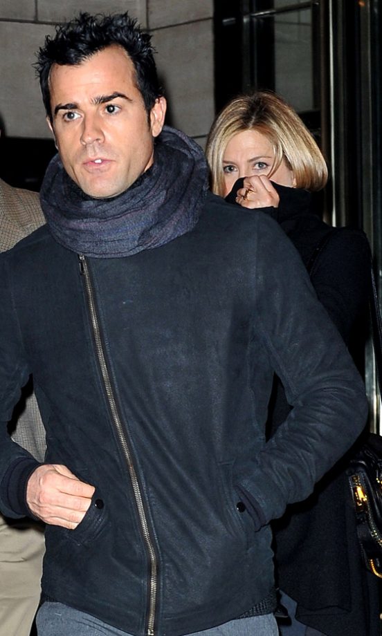 Jennifer Aniston Plays Hide And Seek Behind Justin Theroux As They Leave A Hotel In New York, 2011