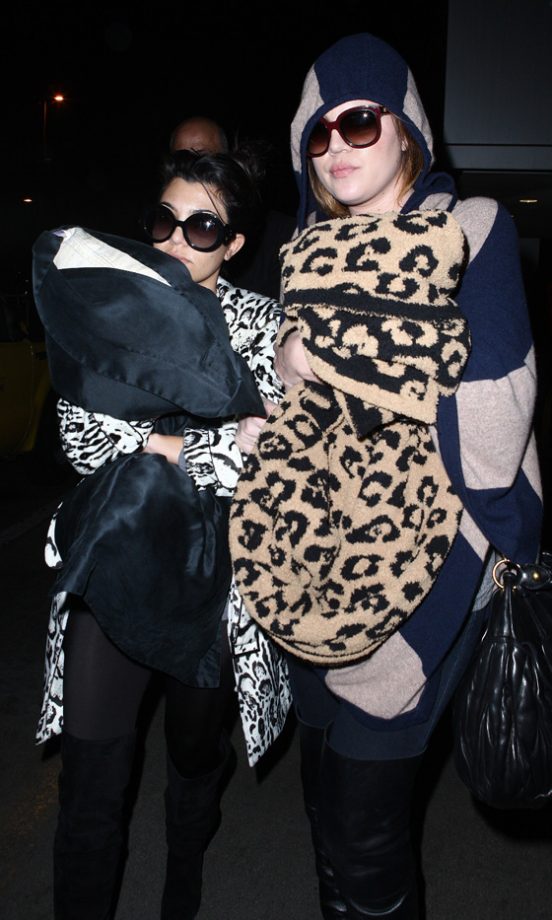 Kourtney Kardashian And Khloe Kardashian Choose Comfort Over Style As They Arrive At LAX Airport, 2011