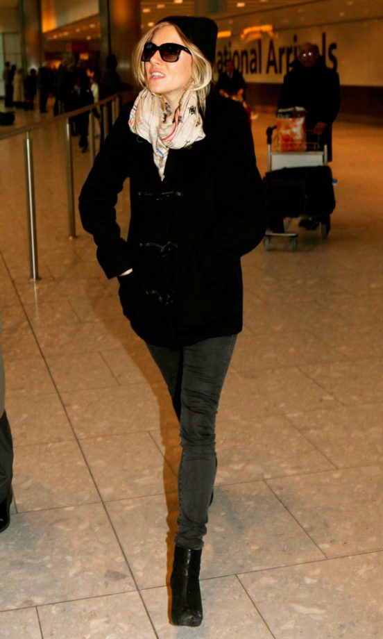 Sienna Miller Covers Up At Heathrow Airport, February 2010