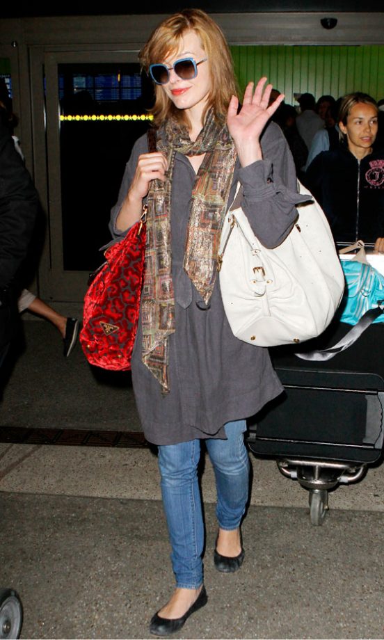 Celebrity Travel Essentials: Milla Jovovich Has It Spot On In Oversized Sunglasses And Not One, But Two, Giant Tote Bags, August 2010