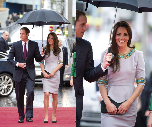 So cute! Wills protects his wife from the rain on the red carpet
