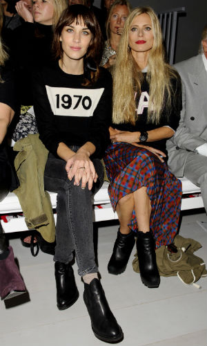 Alexa Chung and Laura Bailey both wearing motif jumpers on the front row at London Fashion Week