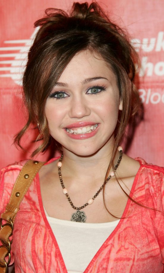 Miley Cyrus Flashes Her Teenage Teeth!