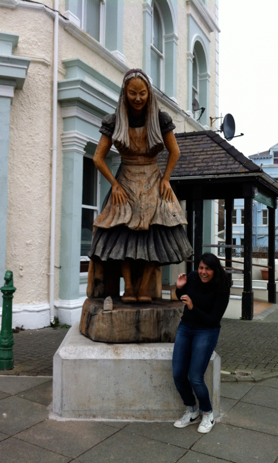 LOOK's Devinder Bains In Front Of A (Rather Scary) Alice Statue
