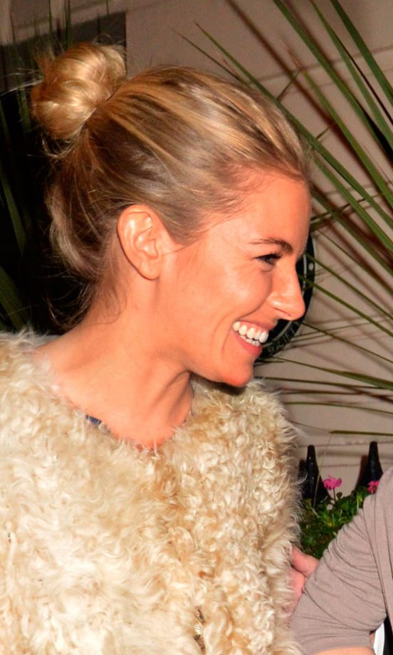 Sienna Miller Pulls Her Blonde Hair Up Into A Topknot Hairstyle, 2011