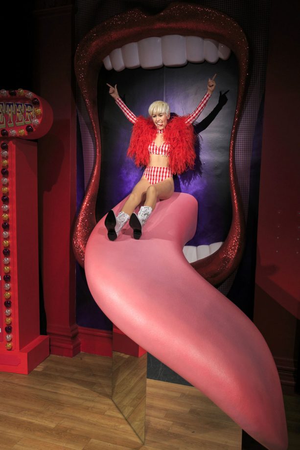 Miley Cyrus Rides Her Tongue Slide At London's Madame Tussauds, 2015