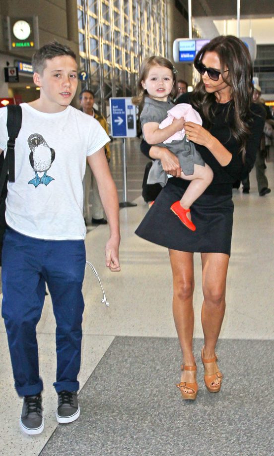 Brooklyn Beckham Escorts Mum Victoria And Daughter Harper Through LAX Airport, 2013