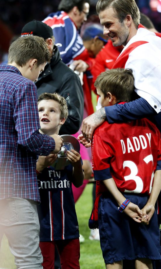 The Beckham Boys Huddle On The Football Pitch After Dad David's Game For Paris Saint-Germain In France, 2013