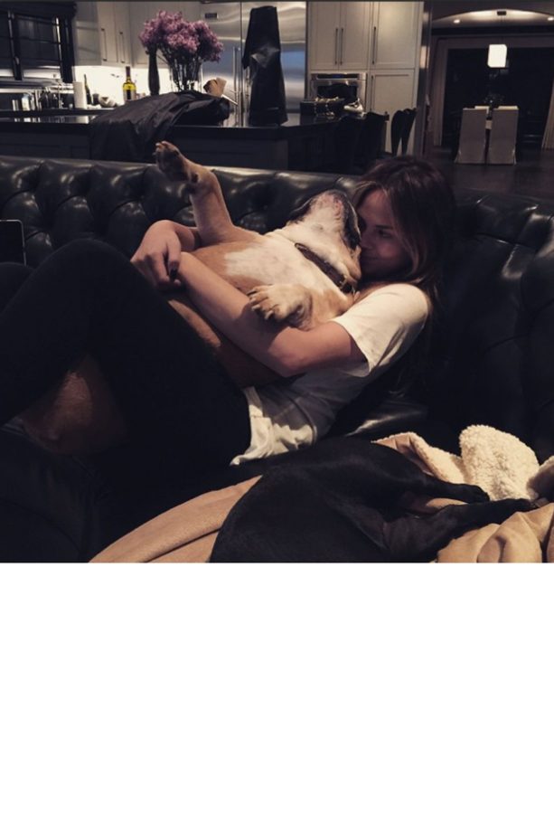 Chrissy Teigen Cuddles Up On The Sofa With One Of Her Dogs Puddy, 2015